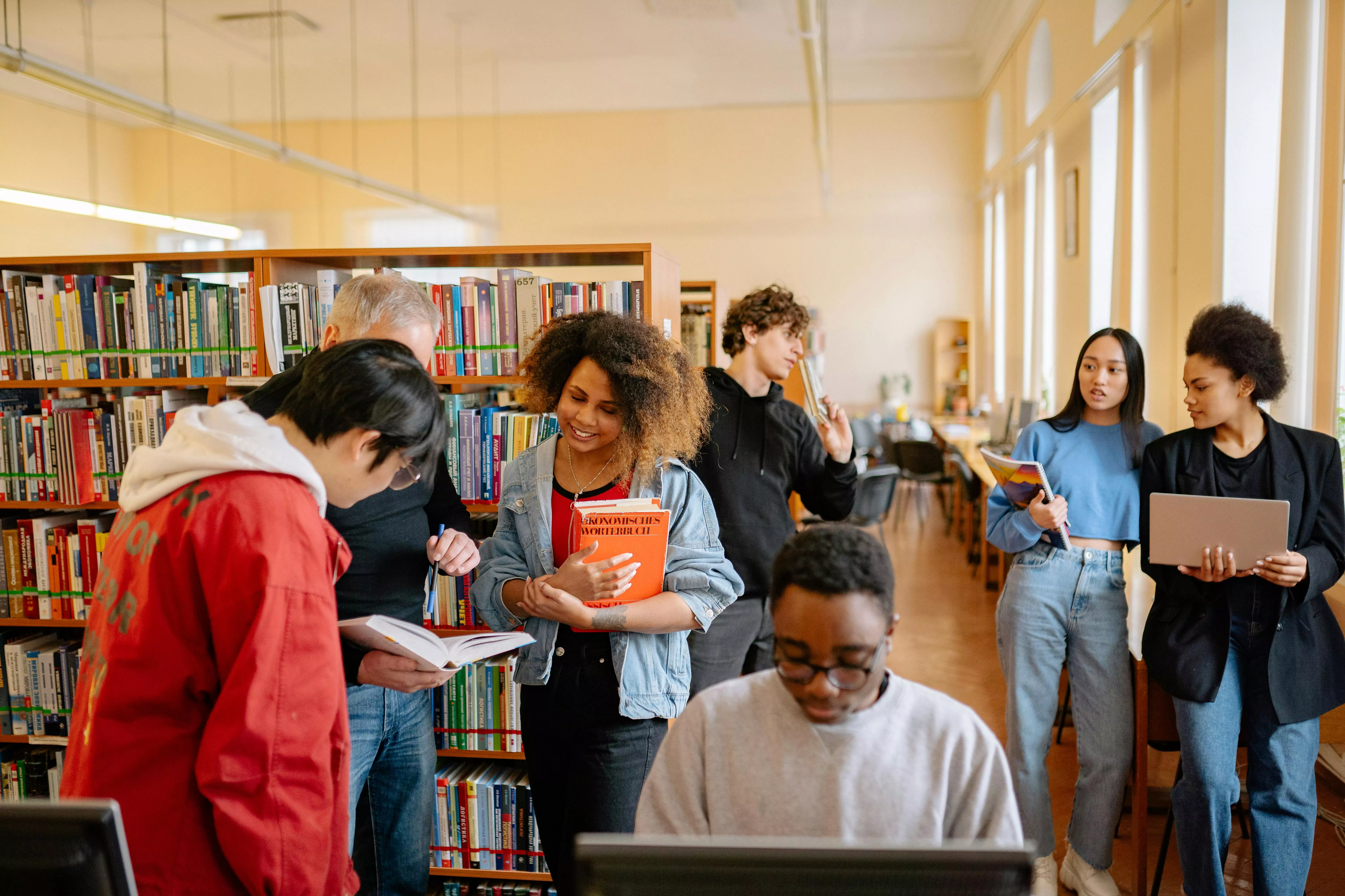 Photo of a group of people in a library together.